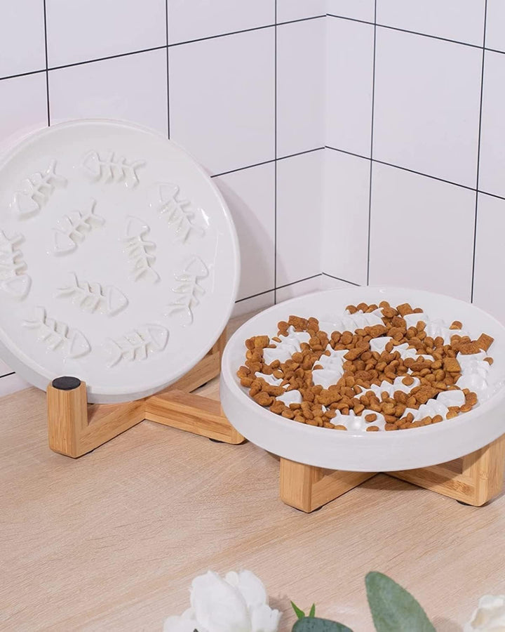 Food in fishbone plate beside extra plate