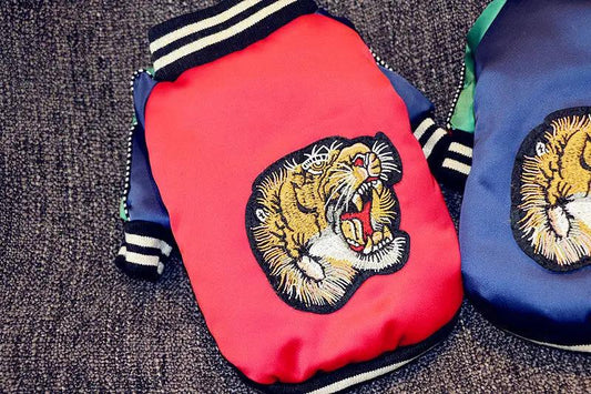 Dog jackets: two red and blue bomber-style jackets with tiger head embroidery.