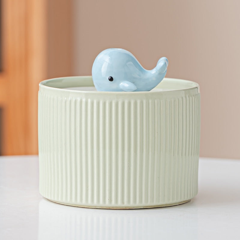Green ribbed fountain with whale centerpiece