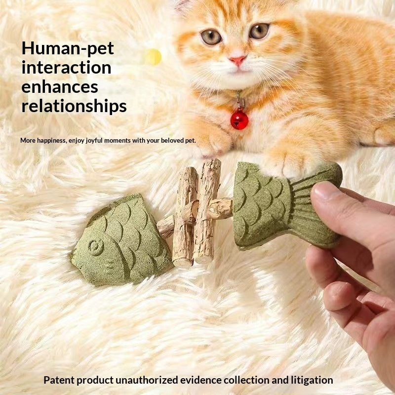 Cat beside green fishbone play stick