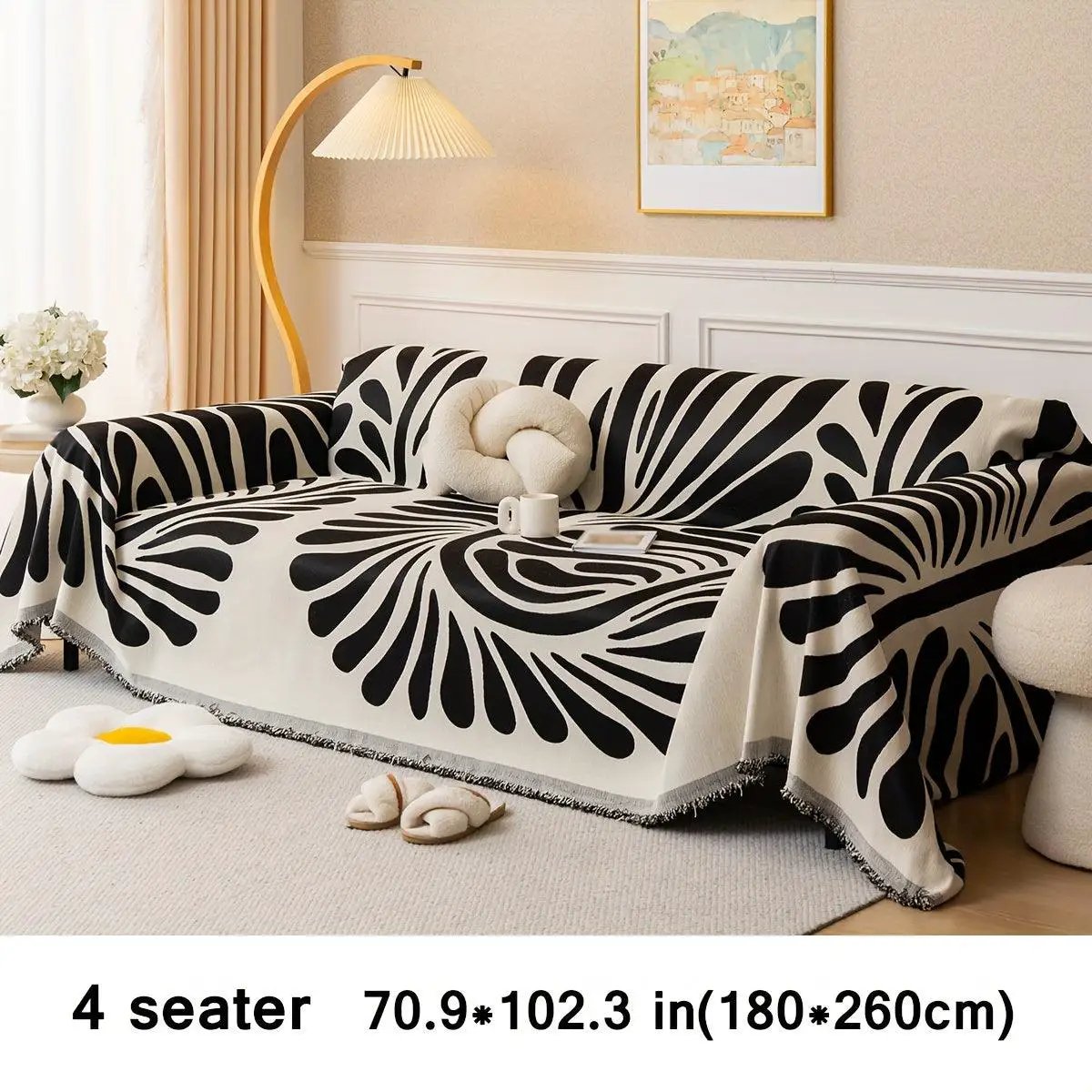 Versatile Chenille Sofa Cover for 4-seat sofa in beige with bold black abstract pattern and fringed edges