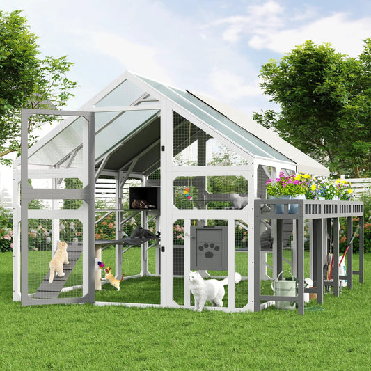 Large grey and white outdoor cat enclosure in wood with wire mesh, planter stand, walk-in access, and multiple cats.