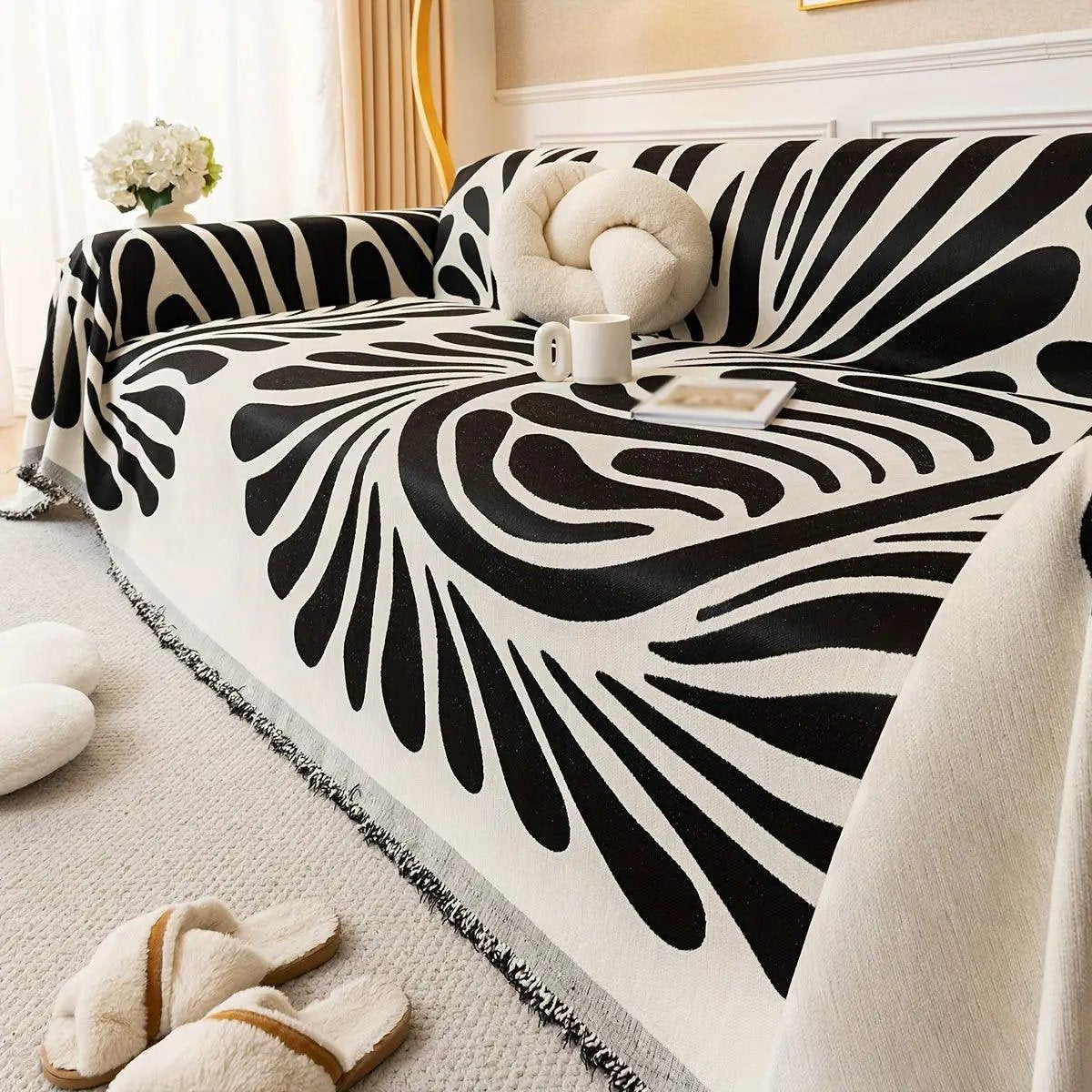 Versatile Chenille Sofa Cover with black-and-white zebra pattern and fringe trim on a sofa