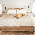 Load image into Gallery viewer, PupProtector™ Waterproof Dog Blanket; cream-colored fluffy throw on a bed.
