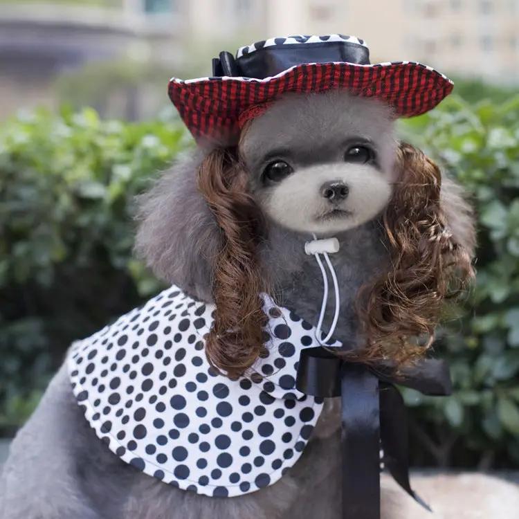 Pet Zen Christmas dog outfit with black-and-white polka dot cape and red plaid hat on a gray poodle