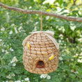 Load image into Gallery viewer, Beehive birdhouse, woven straw design with jute rope hanger for backyard habitat.

