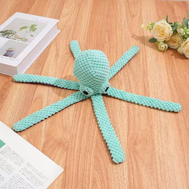 Octopus arms spread on wood surface