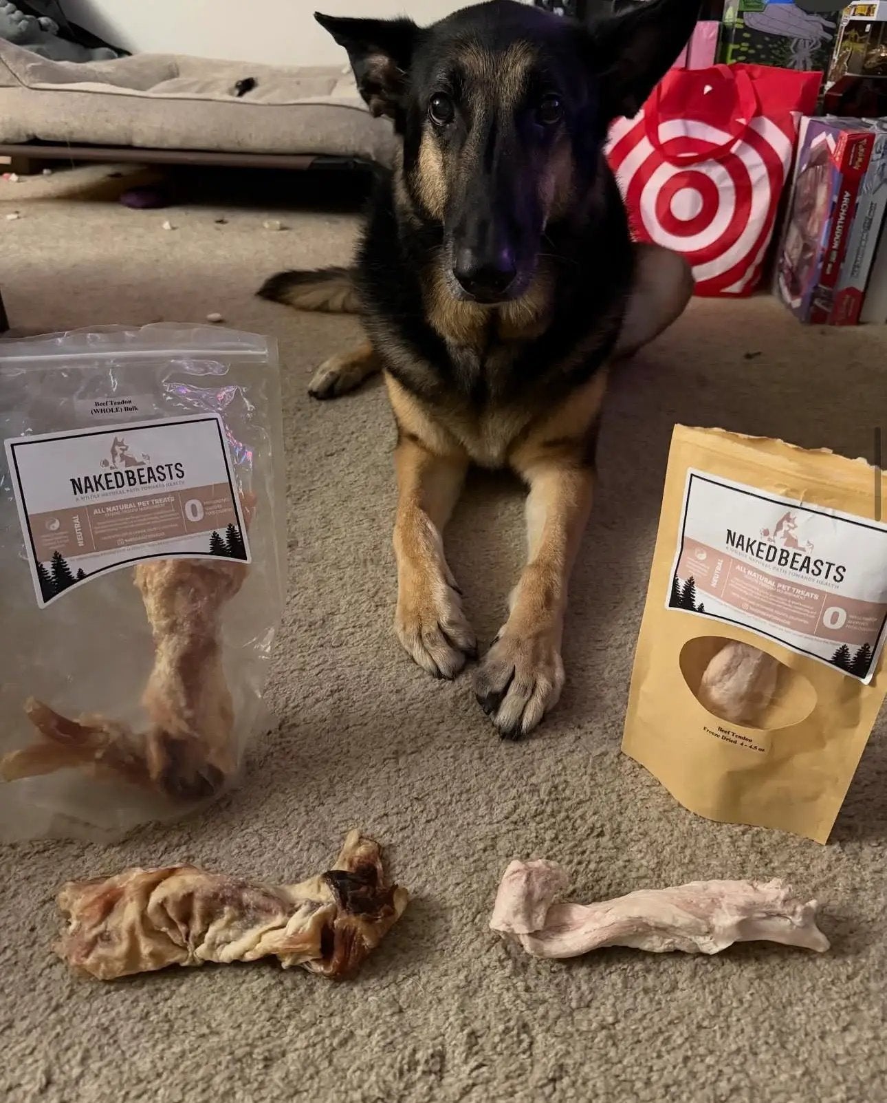 Beef Tendon (Whole & Halved) dog treats by Naked Beasts in a clear bag and beige pouch beside a German Shepherd