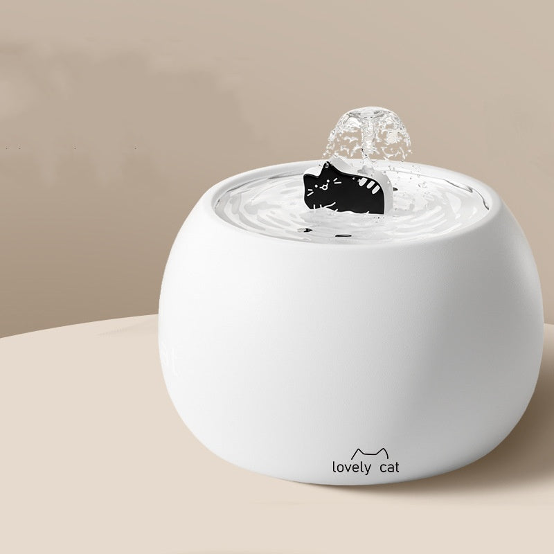 White ceramic fountain with black cat centerpiece