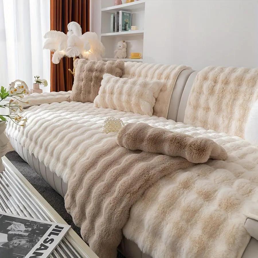 White couch slipcovers with plush faux fur throws on a cream sofa