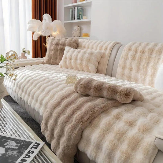 White couch slipcovers with plush faux fur throws on a cream sofa