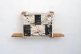 Carica l'immagine nel visualizzatore della galleria, Cat Cubby for Wall by Catastrophic Creations; covered cat bed with black-and-white checker panel and wooden shelves
