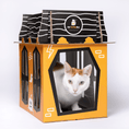 Load image into Gallery viewer, Spooky Cat Haunted House Cardboard Condo by Cat in the Box LLC; orange box with black windows and a cat inside
