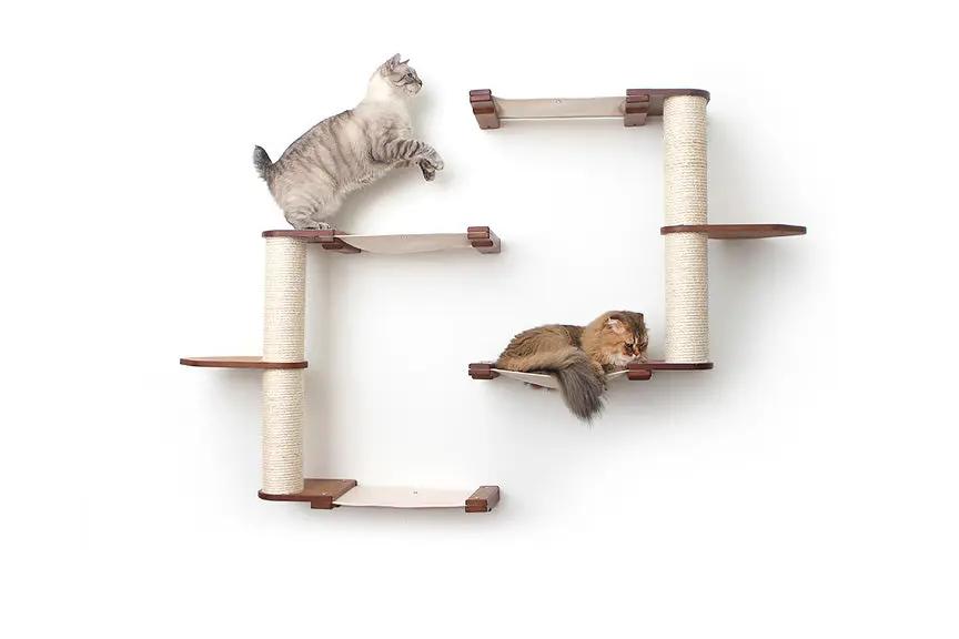 Catastrophic Creations Catacombs cat tree scratching post system; beige condo with sisal posts, shown with two cats.
