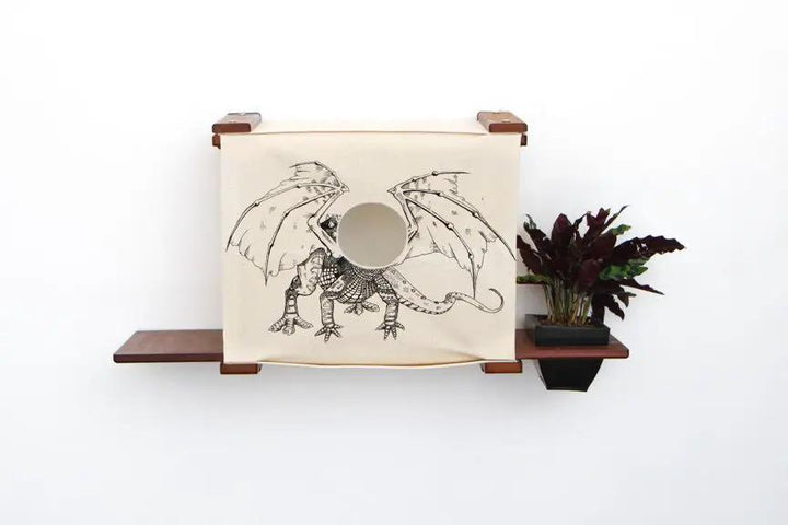 Deluxe Cat Cubby Bed with beige fabric and dragon illustration, mounted on dark wooden shelves.