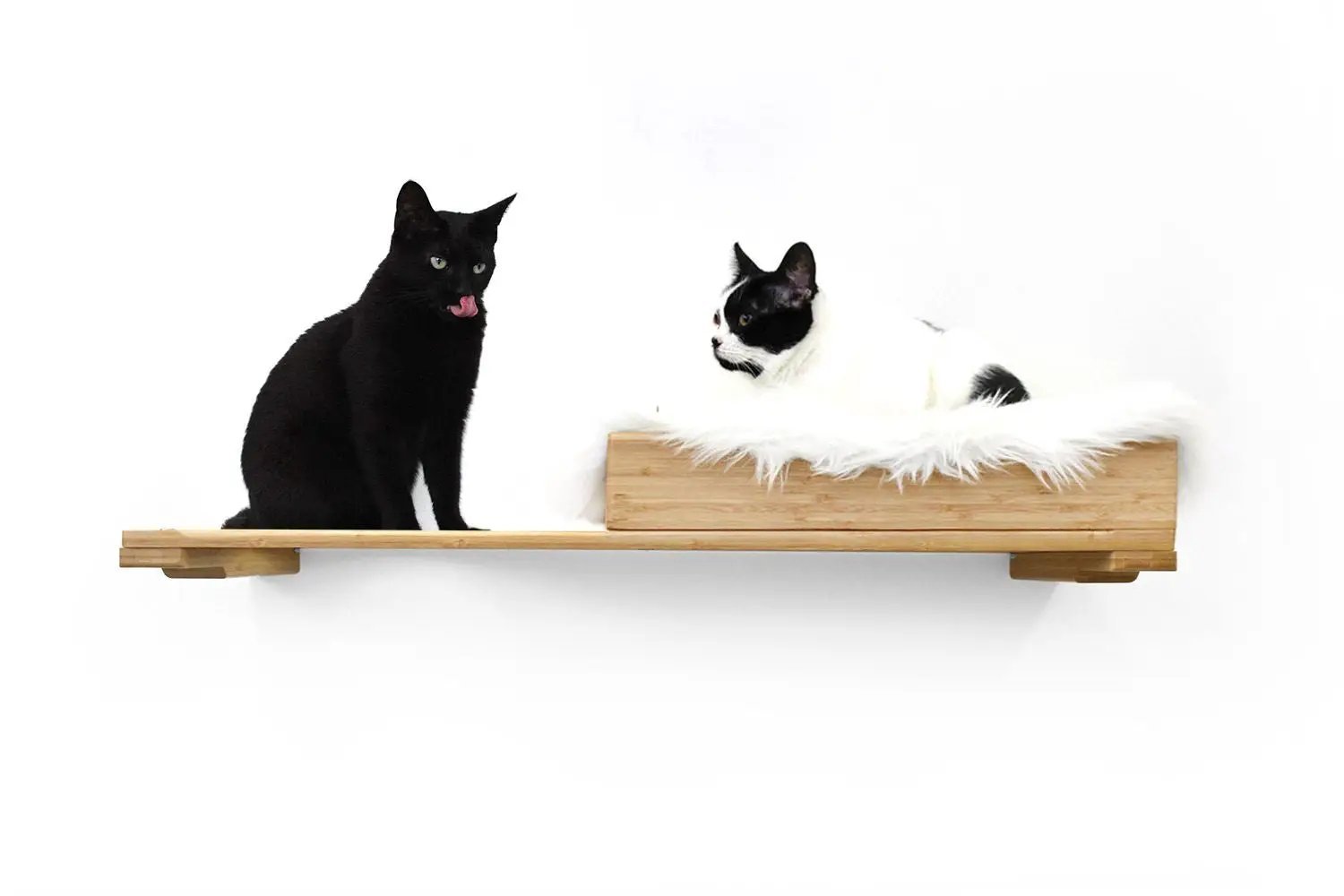 The Cat Nest Bed cat shelf and bed on natural wood plank with white fluffy cushion; two cats.