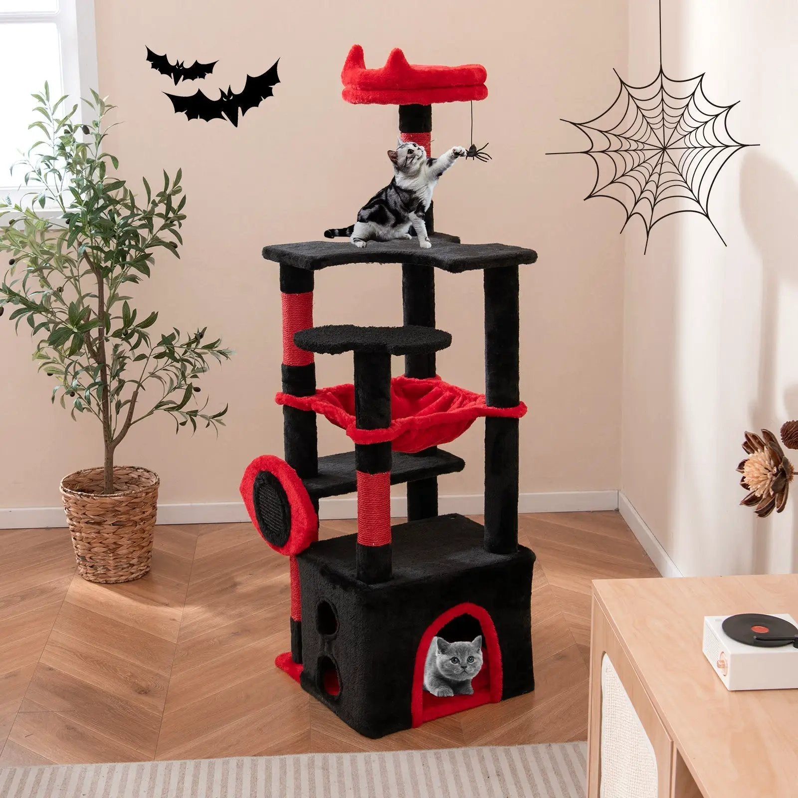 Gothic cat tree in black and red with plush platforms and a dangling spider toy; two cats play on and inside.