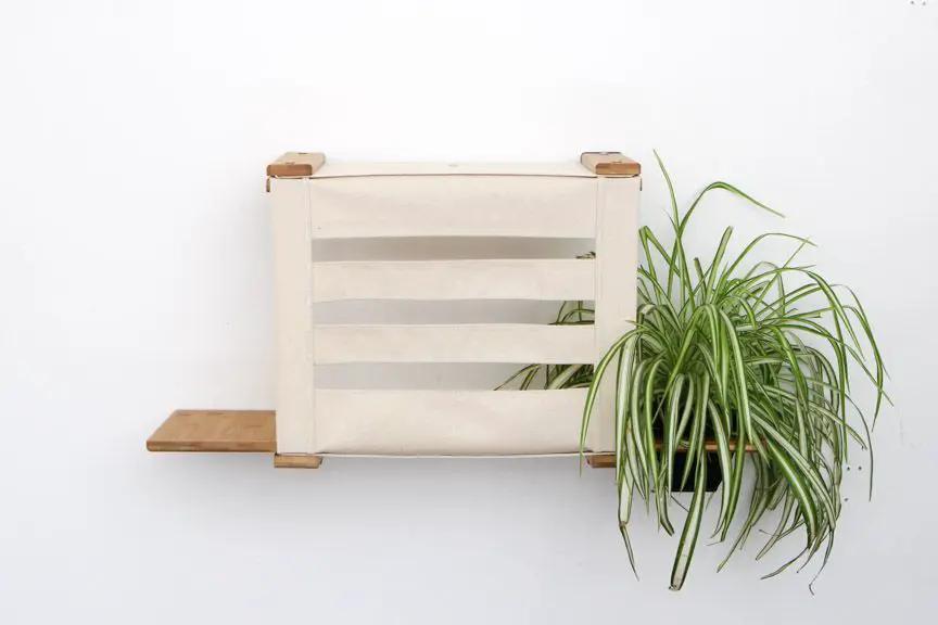 Deluxe Cat Cubby Bed by Catastrophic Creations, beige fabric sling with natural wood frame.