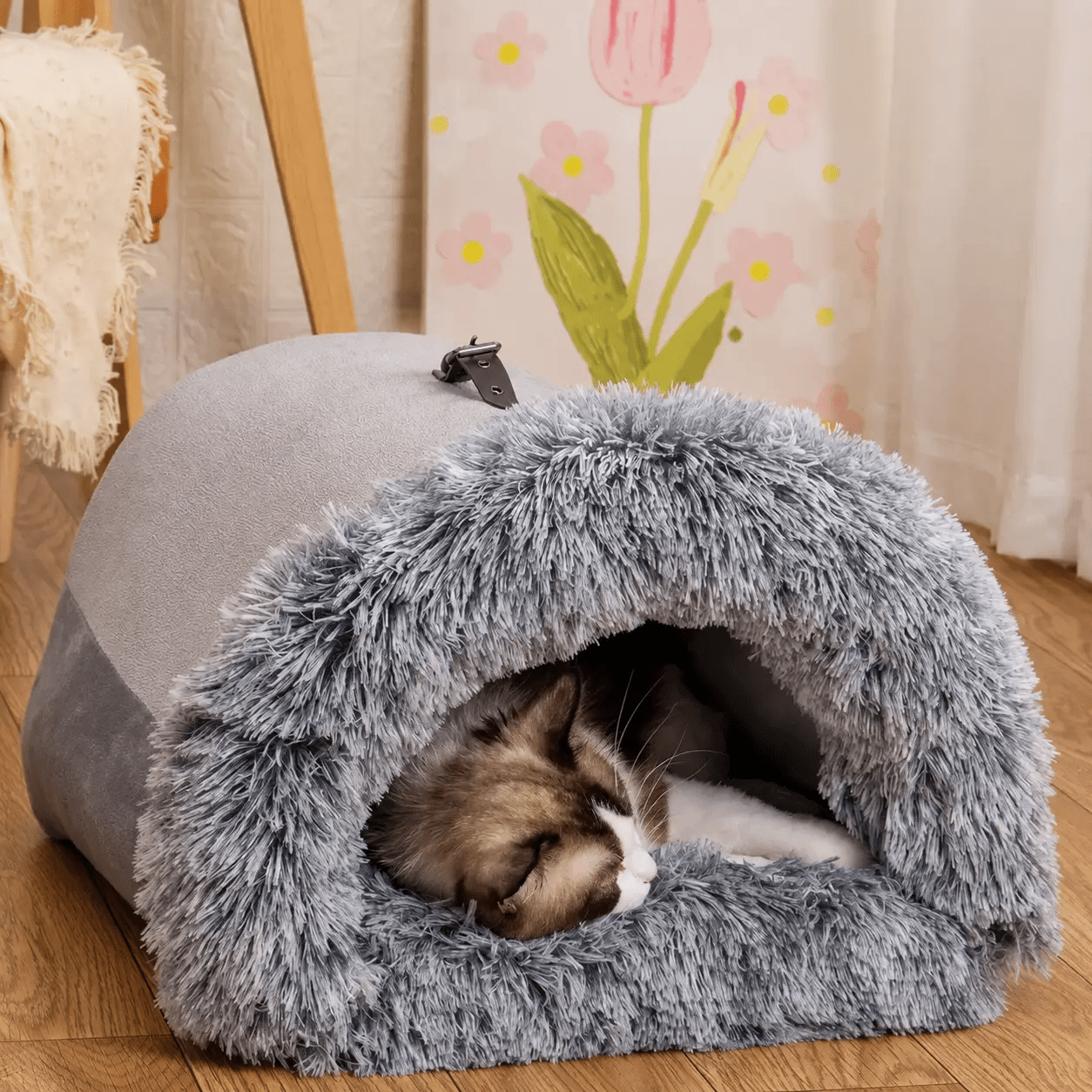 Cozy Haven plush pet house cave for cats and small dogs, gray plush exterior with fuzzy opening, cat sleeping inside.