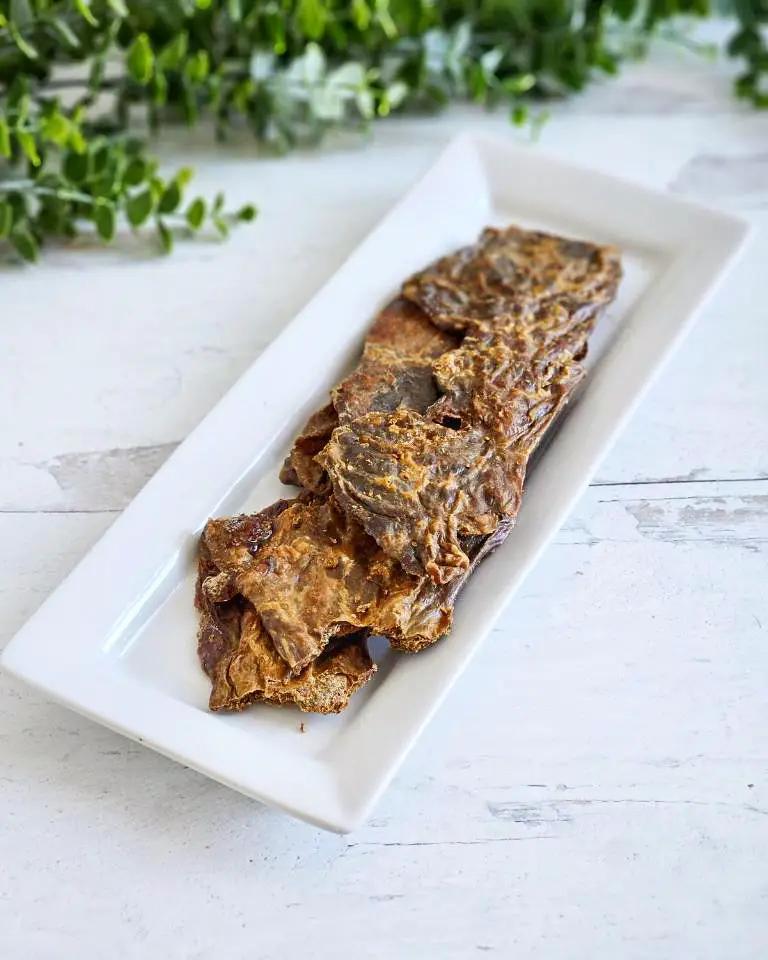 Beef pancreas slices from Naked Beasts, grass-fed and finished, arranged on a white rectangular plate.