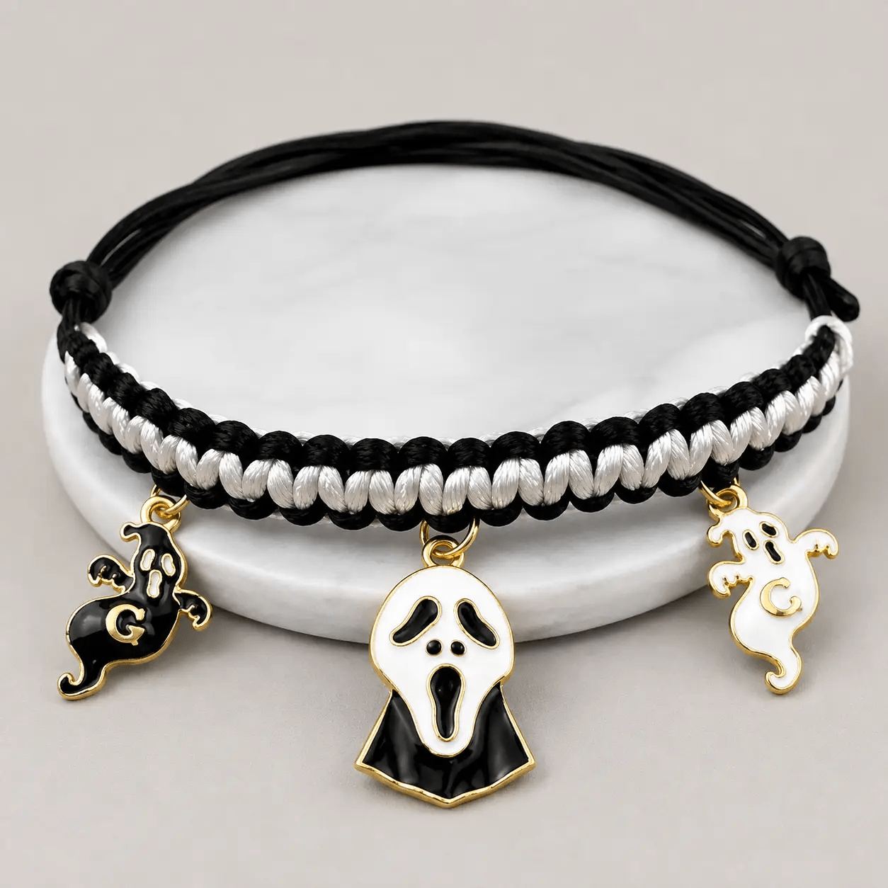 Halloween hand-woven pet collar decoration with black and white braided cord and three gold-edged ghost charms