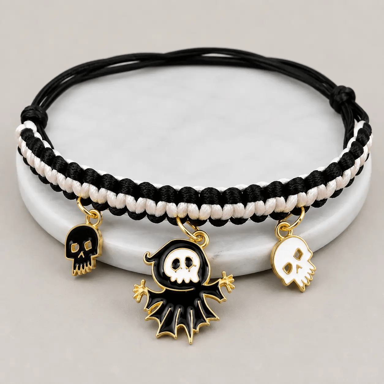 Halloween hand-woven pet collar decoration with black and white braided cord and three gold-edged charms: skull x2 ghost