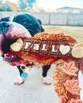 Carica l'immagine nel visualizzatore della galleria, Turkey Wing dog treat by Naked Beasts; bone-shaped chew with white letter tiles on red meat
