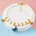 Charger l'image dans la visionneuse de la galerie, The Pearl & Crystal Pet Necklace with white pearl beads, gold spacers, and a blue butterfly charm.
