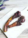 Load image into Gallery viewer, Beef Pizzle (Sticks) – Limited Edition by Naked Beasts on a white plate; dark brown dried meat
