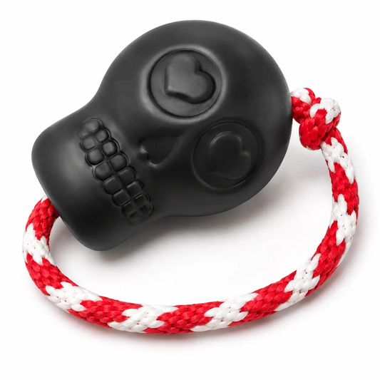 Rubber skull chew toy by SodaPup, USA-made, black with red-and-white braided rope