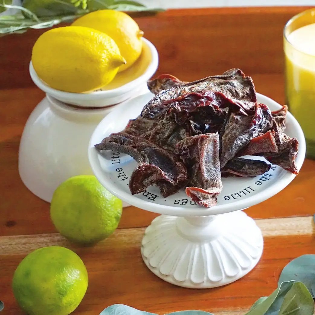 Beef tongue thin-cut slices on a white pedestal dish