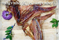 Carica l'immagine nel visualizzatore della galleria, Turkey wings (XL and L) on a wooden cutting board with a purple flower and green sprigs
