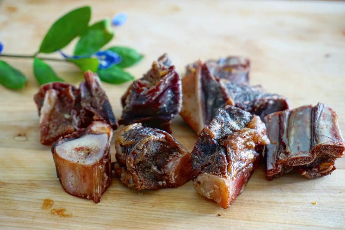Goat Cubes bone-in, Naked Beasts free-range meat chunks on a cutting board.