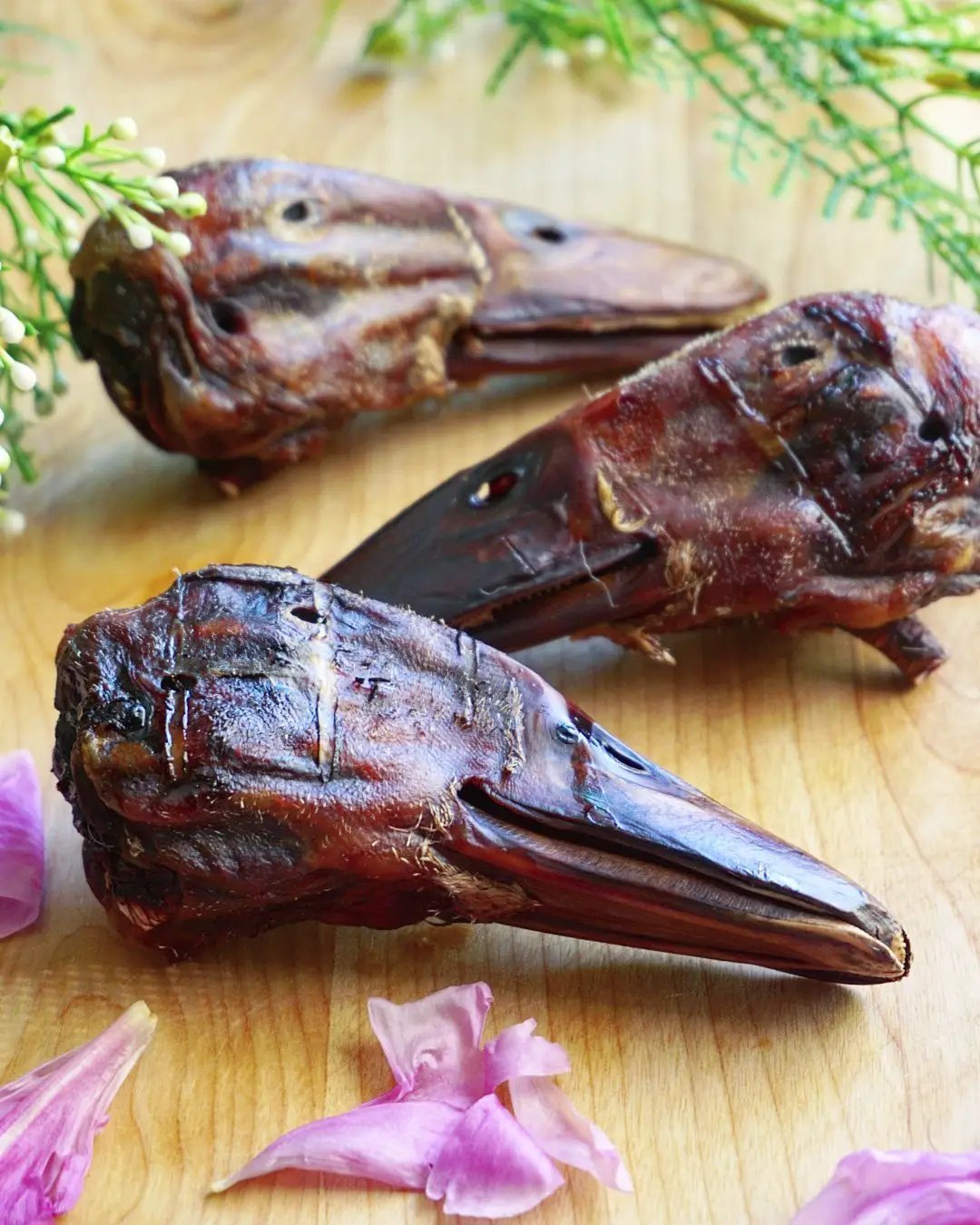 Duck Heads (ABF) Naked Beasts; three dried brown duck heads on a wooden board.