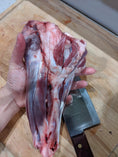 Load image into Gallery viewer, Two lamb shanks from Naked Beasts, pasture-raised, bone-in cuts on a wooden cutting board
