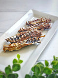 Load image into Gallery viewer, Chicken Frames (Chunked) - Naked Beasts on a white platter with bone-in, crispy roasted pieces
