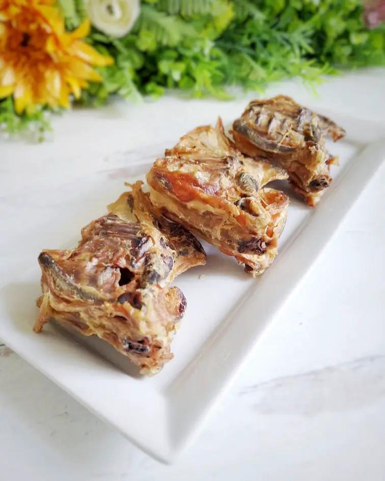 Chicken frames (chunked) by Naked Beasts on a white plate; fried, golden-brown pieces with bones.