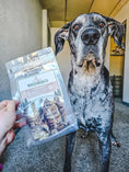 Load image into Gallery viewer, Beef Trachea treats by Naked Beasts, grass-fed and finished, in a clear bag beside a dog.
