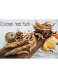 Load image into Gallery viewer, Chicken Feet pack by Naked Beasts on a wooden board with decorative gourds
