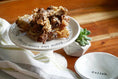 Load image into Gallery viewer, Naked Beasts chicken necks on a white plate; several crispy brown fried pieces.
