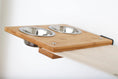 Load image into Gallery viewer, Cat condo The Bunker by Catastrophic Creations; bamboo wood panel with two stainless steel bowls
