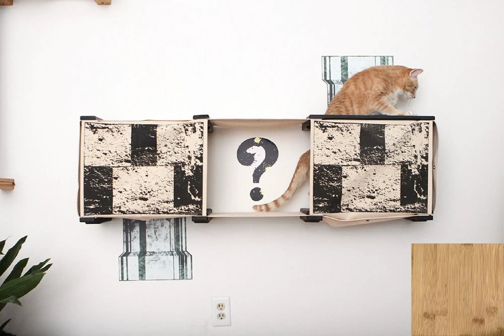 Super Mario Cat Tree Cat Condo by Catastrophic Creations; beige unit with black checker panels and an orange tabby.