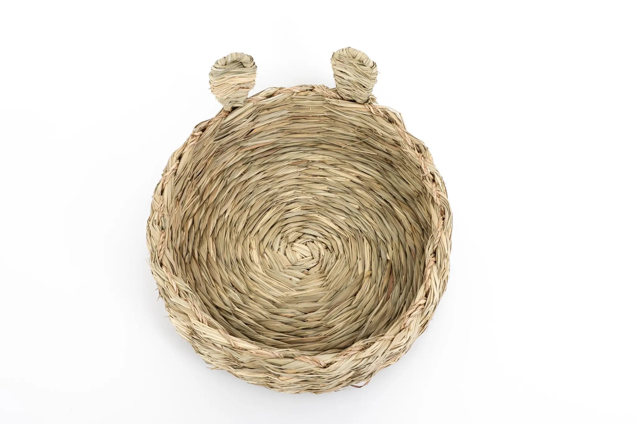 Bunny Bed by Clover Days, woven straw round pet bed with two ear-shaped projections.
