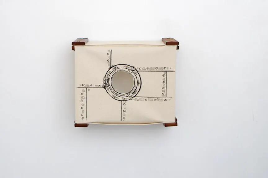 Enclosed Cat Bed Cat Wall Cubby in beige fabric with round porthole and riveted metal accents.