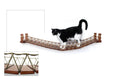 Load image into Gallery viewer, Cat Bridge for Wall by Catastrophic Creations, brown wooden posts with woven rope bridge and a cat on it
