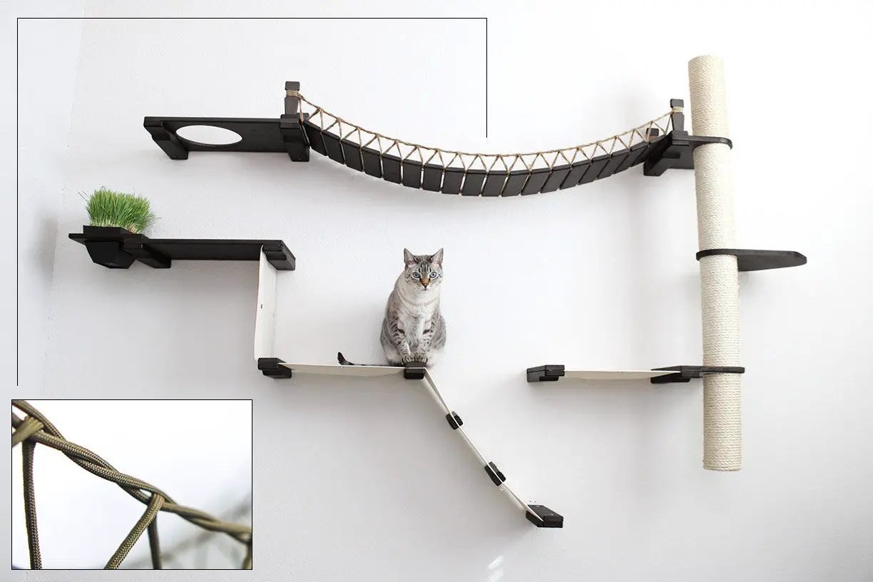 The Expedition Cat Jungle Gym Wall System wall-mounted cat condo with dark wood platforms and rope bridge.