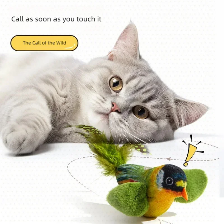 Cat playing with hanging green bird