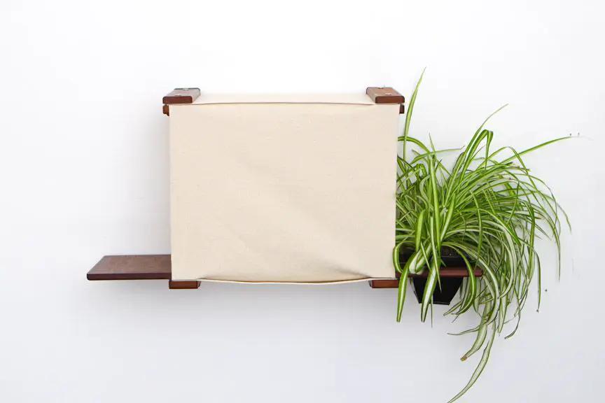 Deluxe Cat Cubby Bed in beige fabric with a wooden frame.