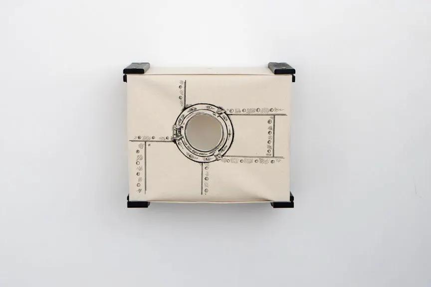 Enclosed Cat Bed - Cat Wall Cubby by Catastrophic Creations; beige riveted panel with circular porthole.