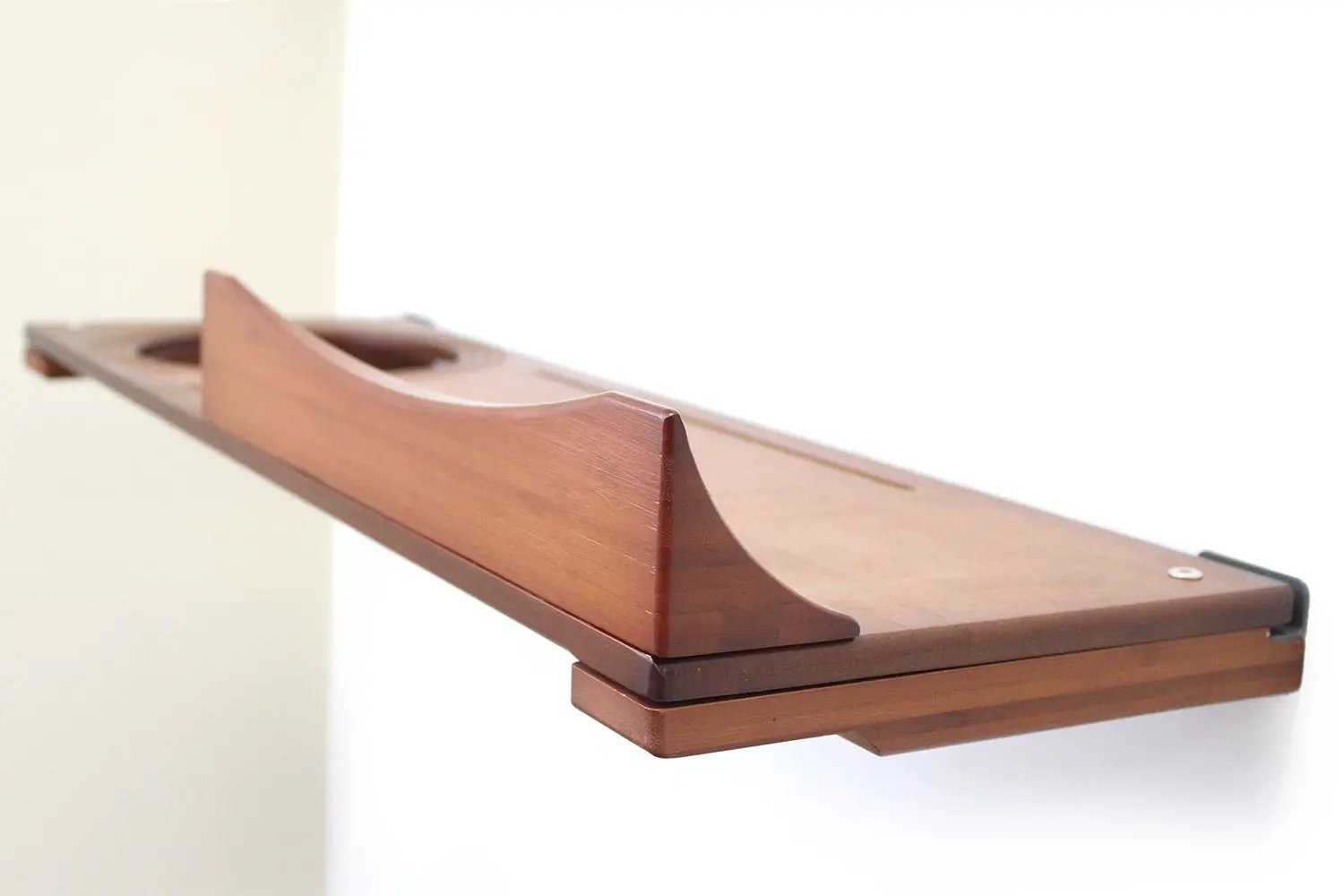 The Cat Nest Bed by Catastrophic Creations, brown wooden cat shelf/bed with curved nest opening.